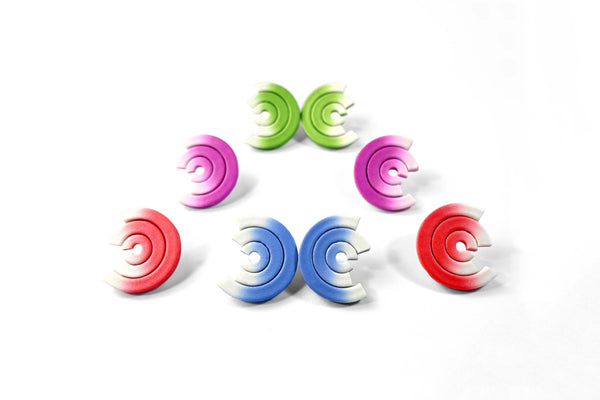 Grupo de pendientes de arcilla polimérica modelo Mistral con diseño en varios colores en degradado desde blanco 