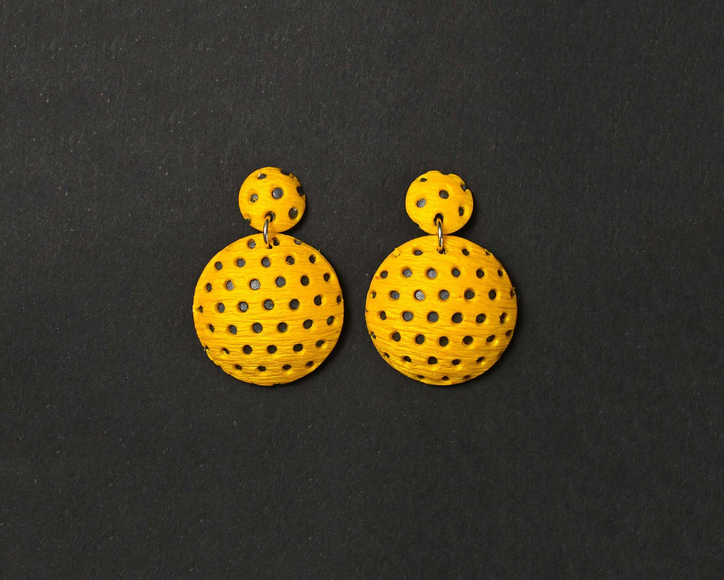 Imagen de los pendientes hechos a mano, modelo Polka Dots en color amarillo sobre fondo negro